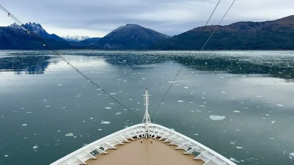 An expedition ship’s bow in an icy fjord