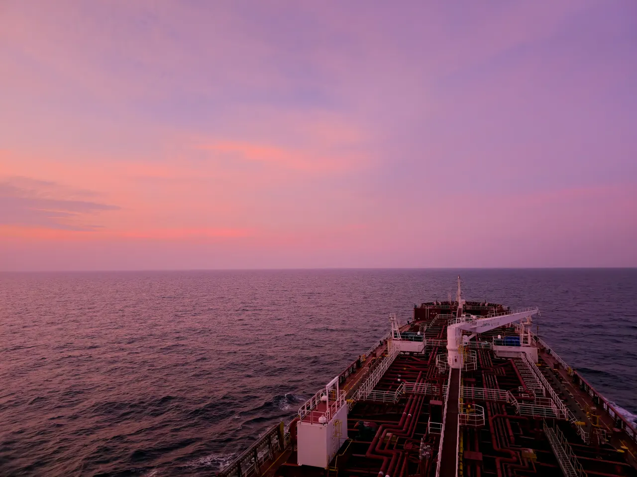 Stunning sunset view across the open sea from the deck of a cargo ship.