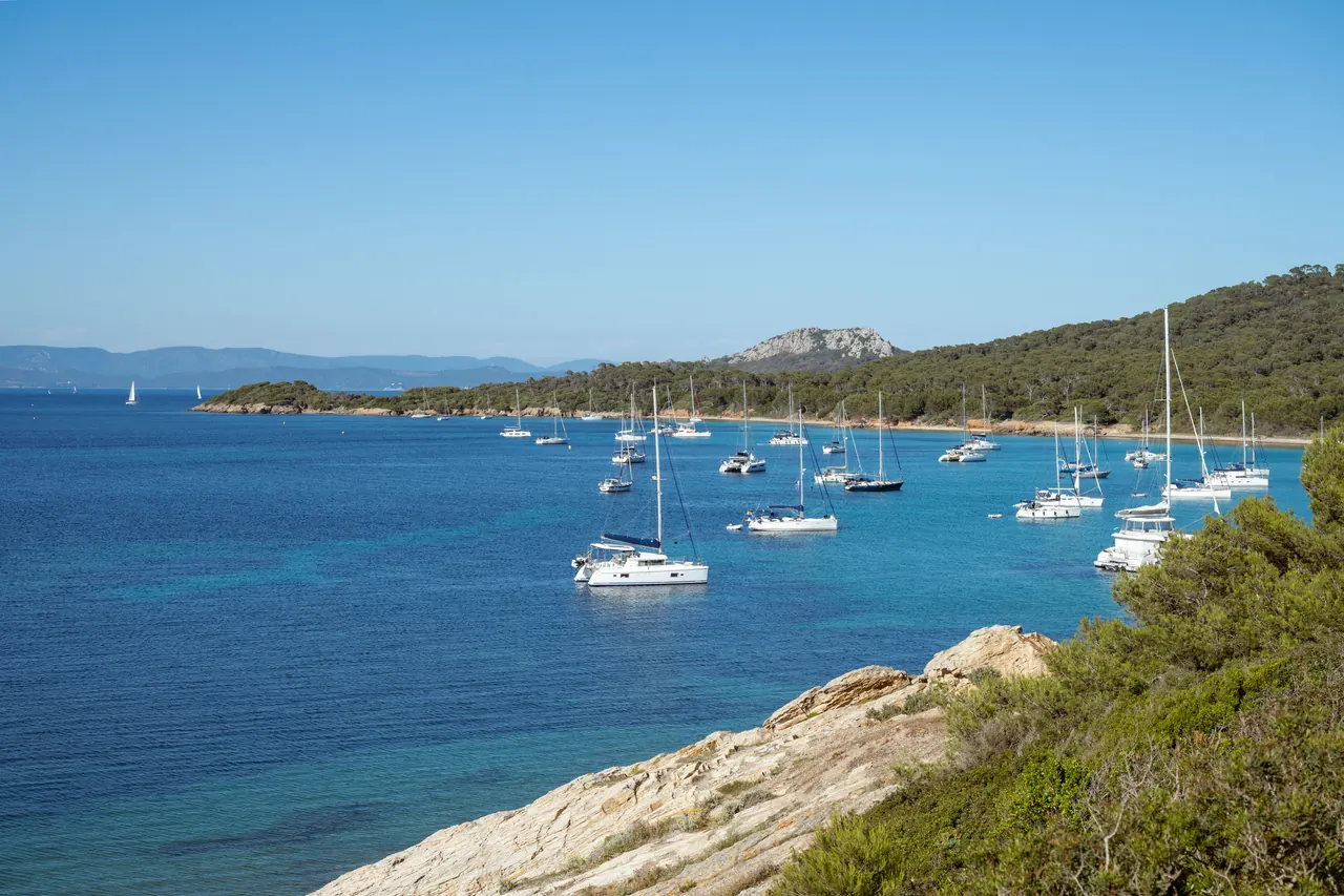 Beautiful coastal scene with yachts at anchor in the clear blue waters of the French Riviera.