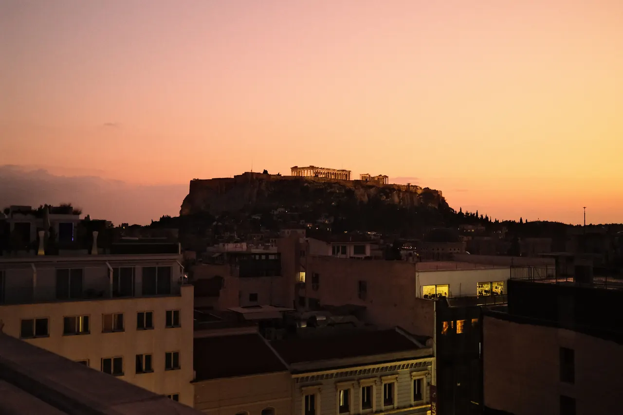 A stunning aerial view of Athens cityscape at sunrise, showcasing historical landmarks.