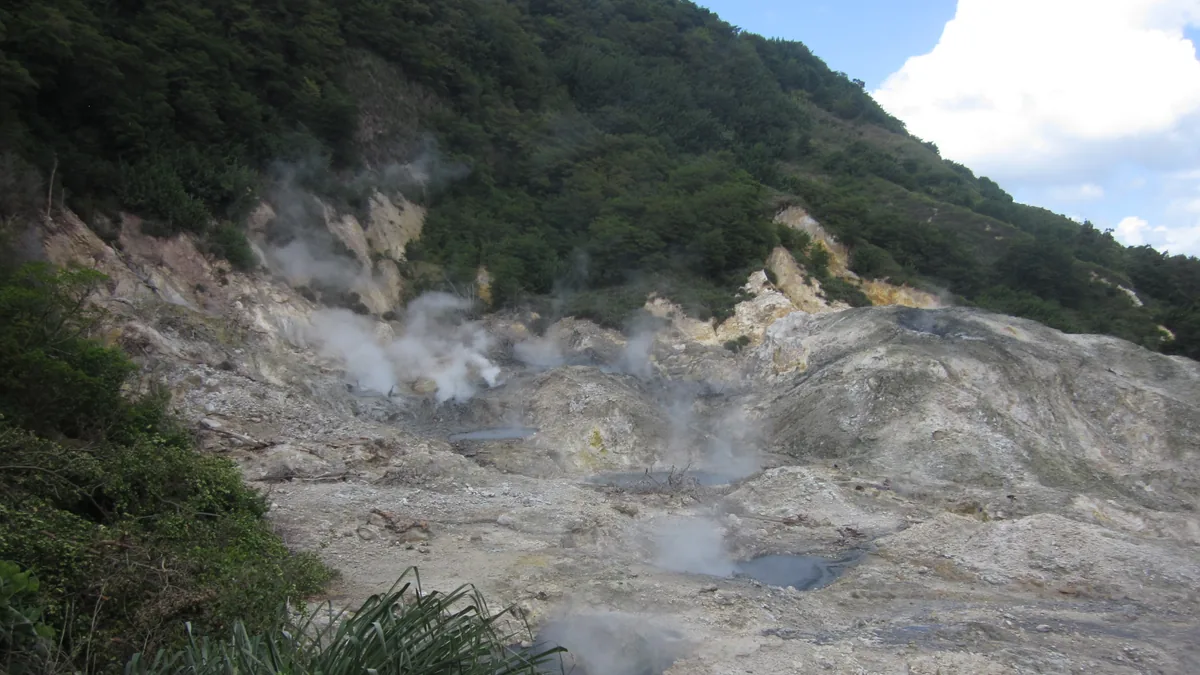Steaming vents and gray mineral pools at Sulphur Springs, Soufrière, Saint Lucia