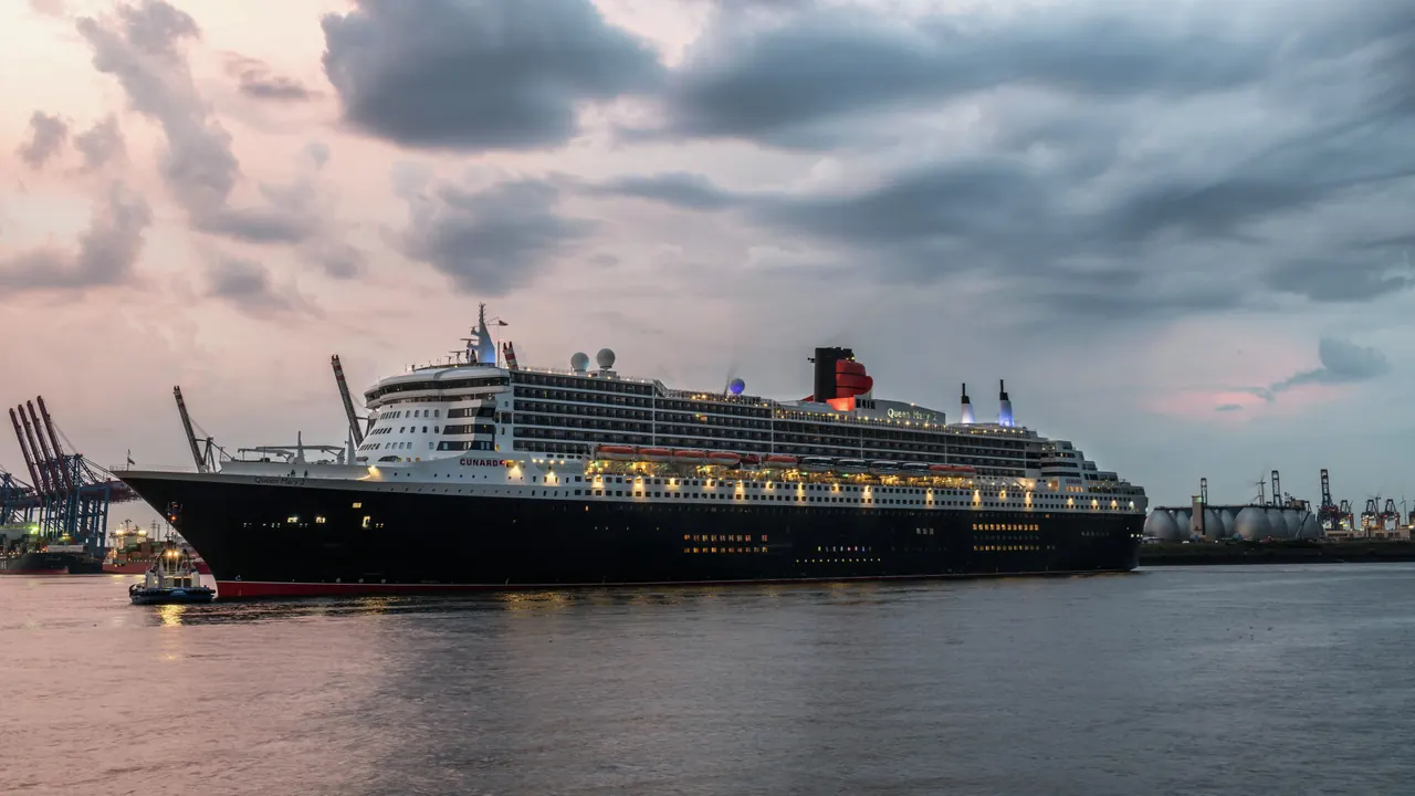 Queen Mary 2 docked at Hamburg harbor during a serene evening, showcasing maritime elegance.