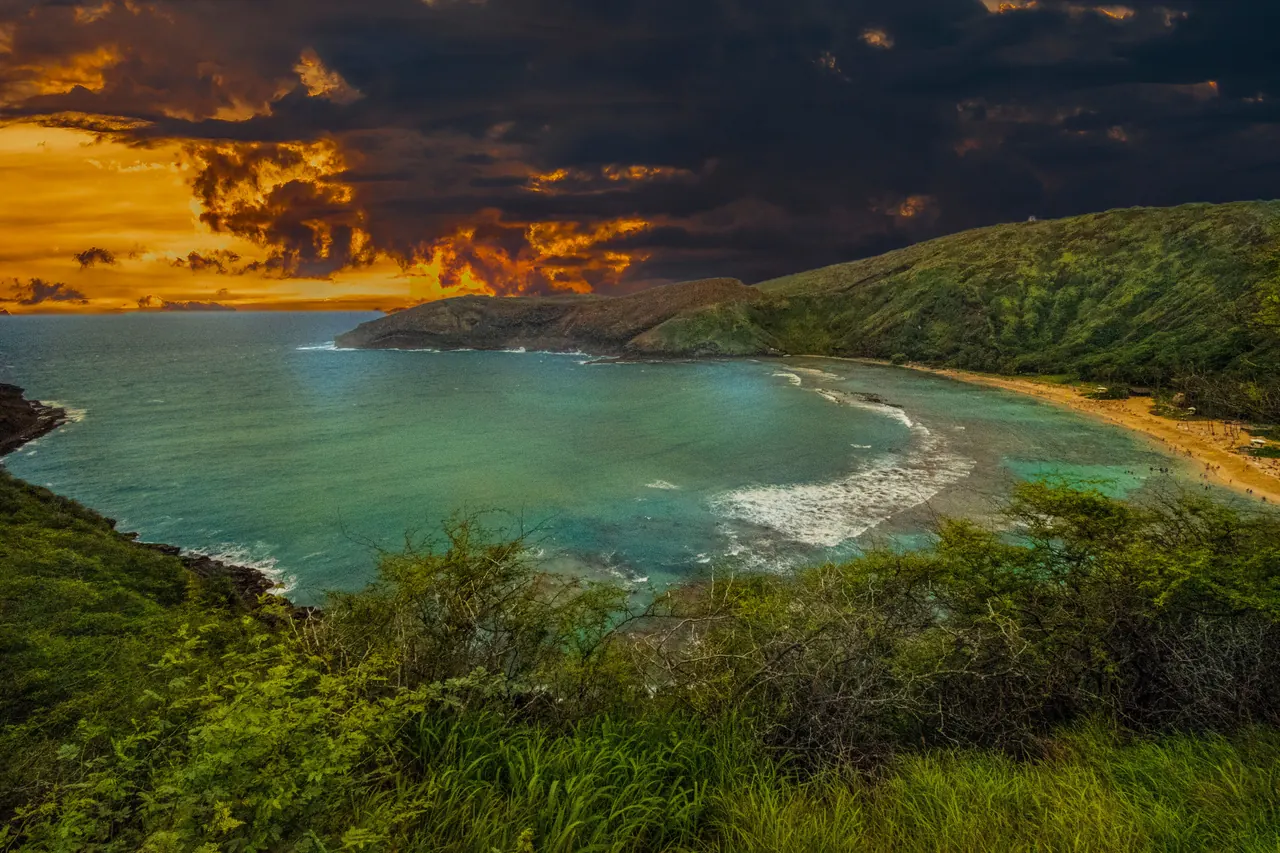 Capture the beauty of a tropical beach with a dramatic sunset sky and turquoise waters.