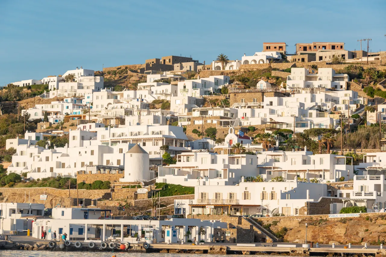 Scenic view of traditional white homes on a Greek island during daytime.