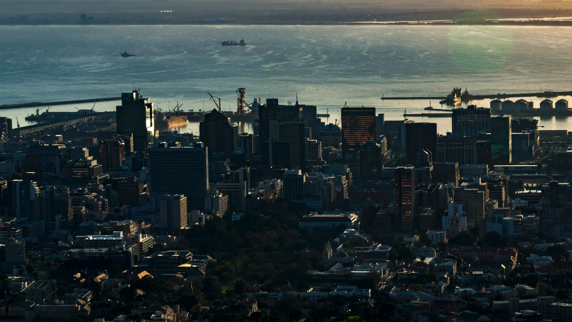 Cape Town’s city center and working harbor seen from the slopes of Table Mountain in early morning light