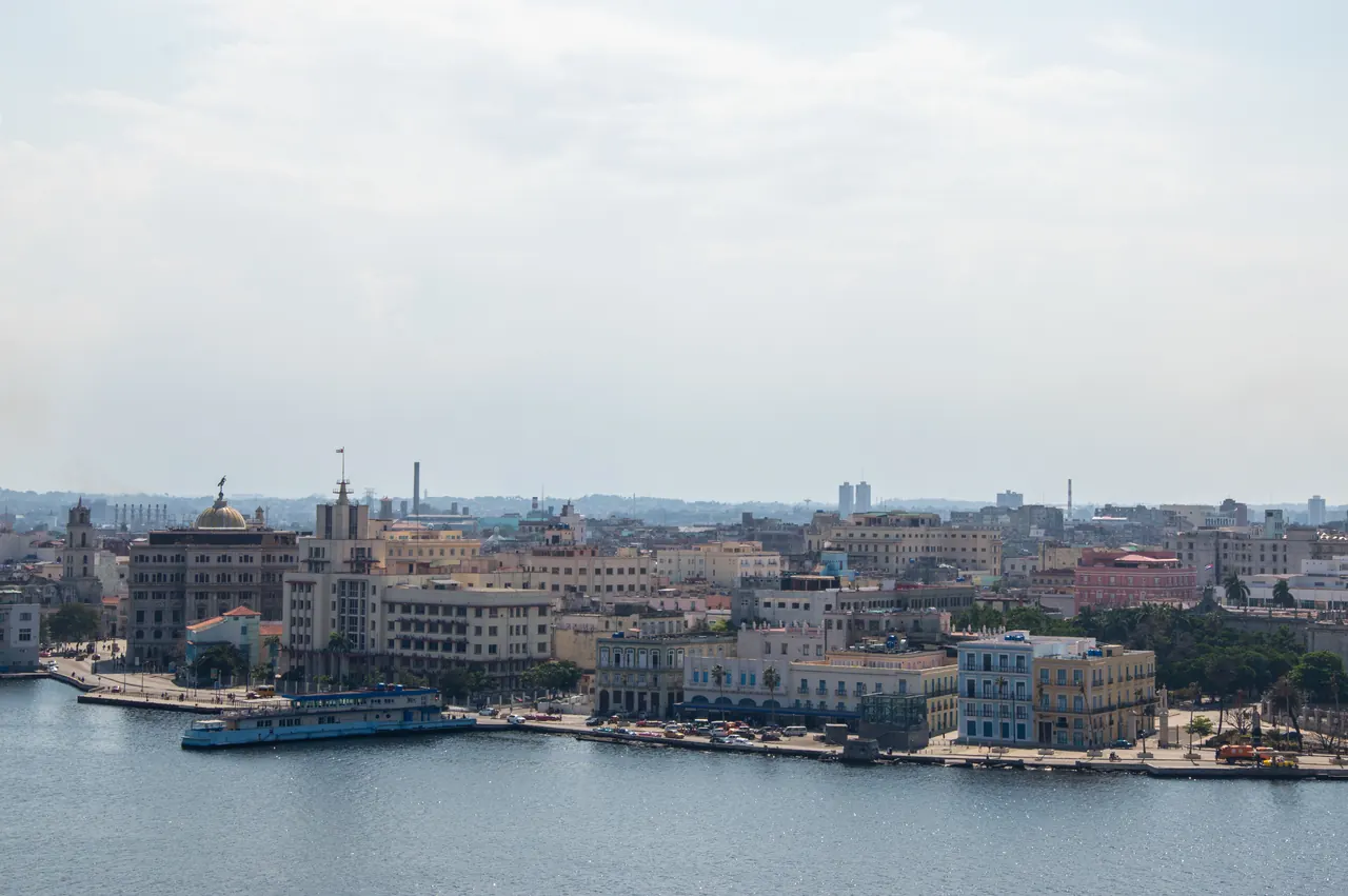 Panoramic aerial view of the picturesque waterfront in Havana with historic buildings and bay.