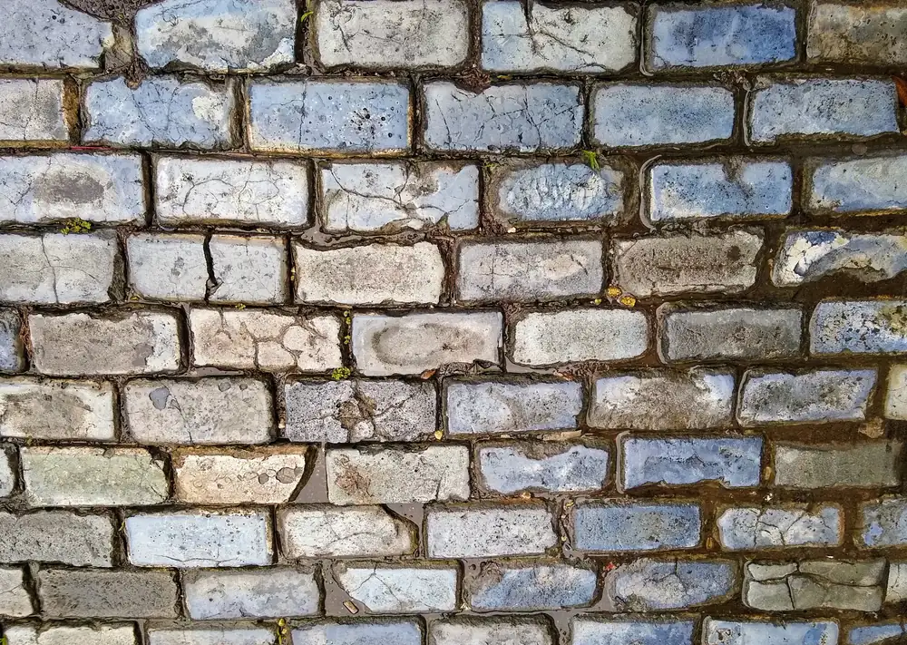 Blue-gray adoquines cobblestones paving a street in Old San Juan, worn smooth and set in tight rows