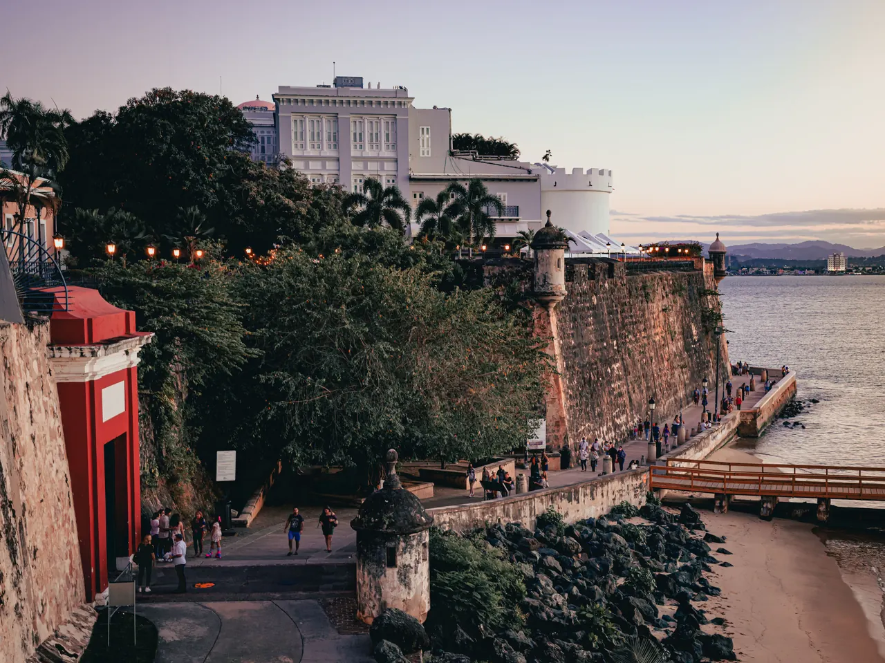 Scenic view of Old San Juan’s coastal wall and paseo at sunset, Puerto Rico.