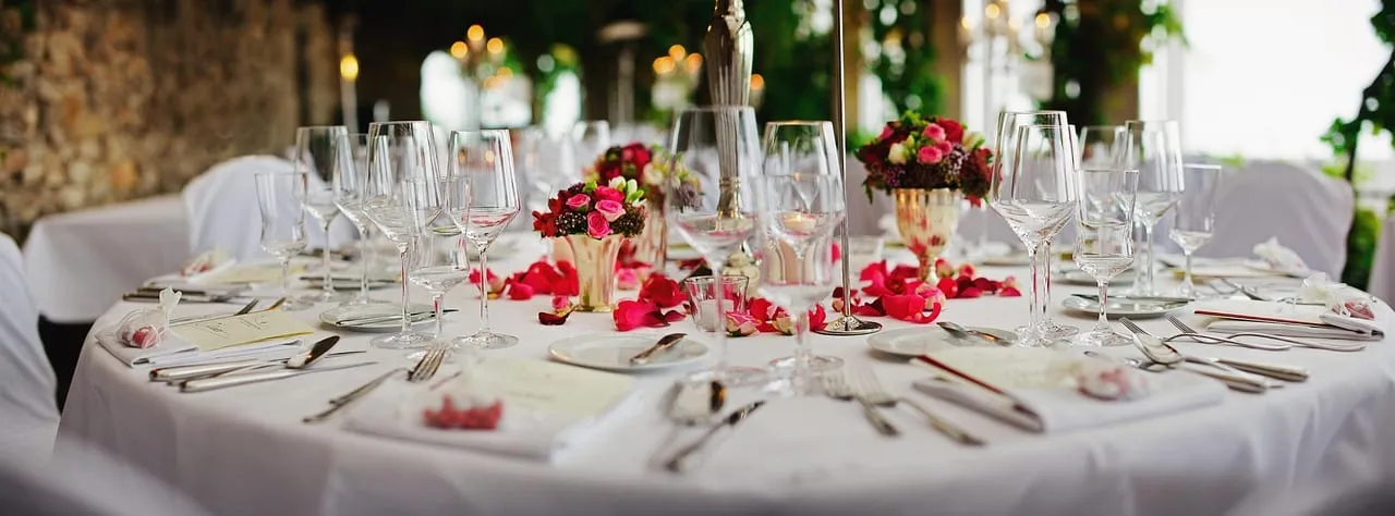 A single place setting at an ocean-view table at sunset — dining solo at sea