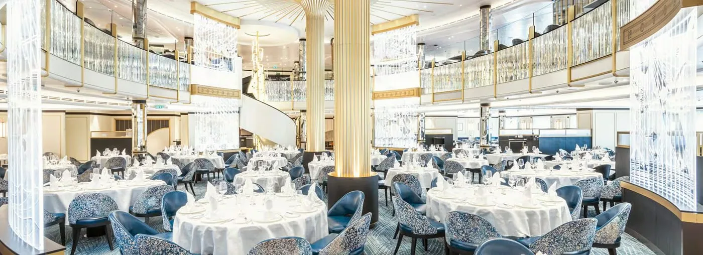 Crystal chandeliers and ocean-view tables in the Britannia Restaurant aboard Cunard's Queen Anne