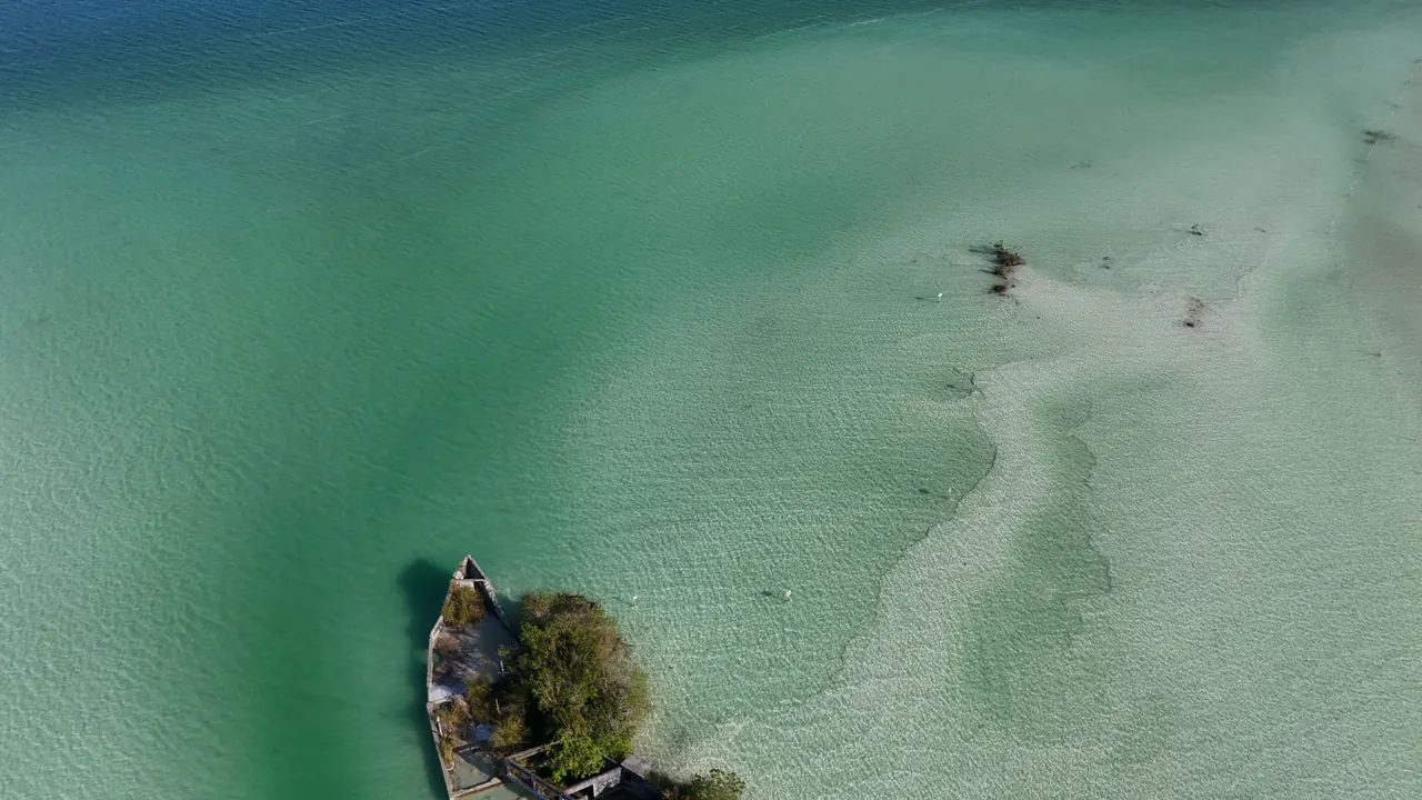 Stunning aerial view of Bacalar Lagoon with its clear turquoise waters and lush greenery.