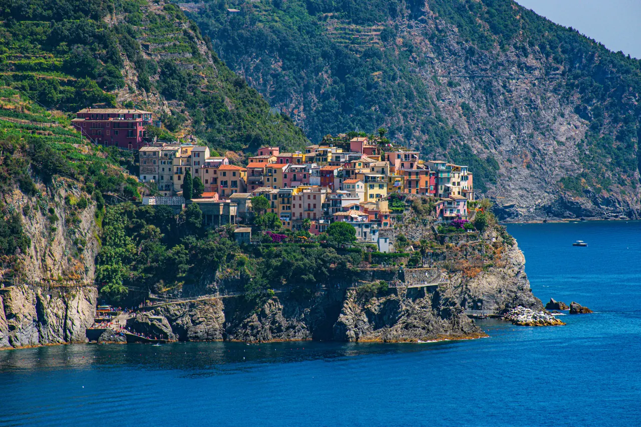 Beautiful aerial view of Corniglia, a picturesque village perched on cliffs overlooking the Ligurian Sea in Italy.