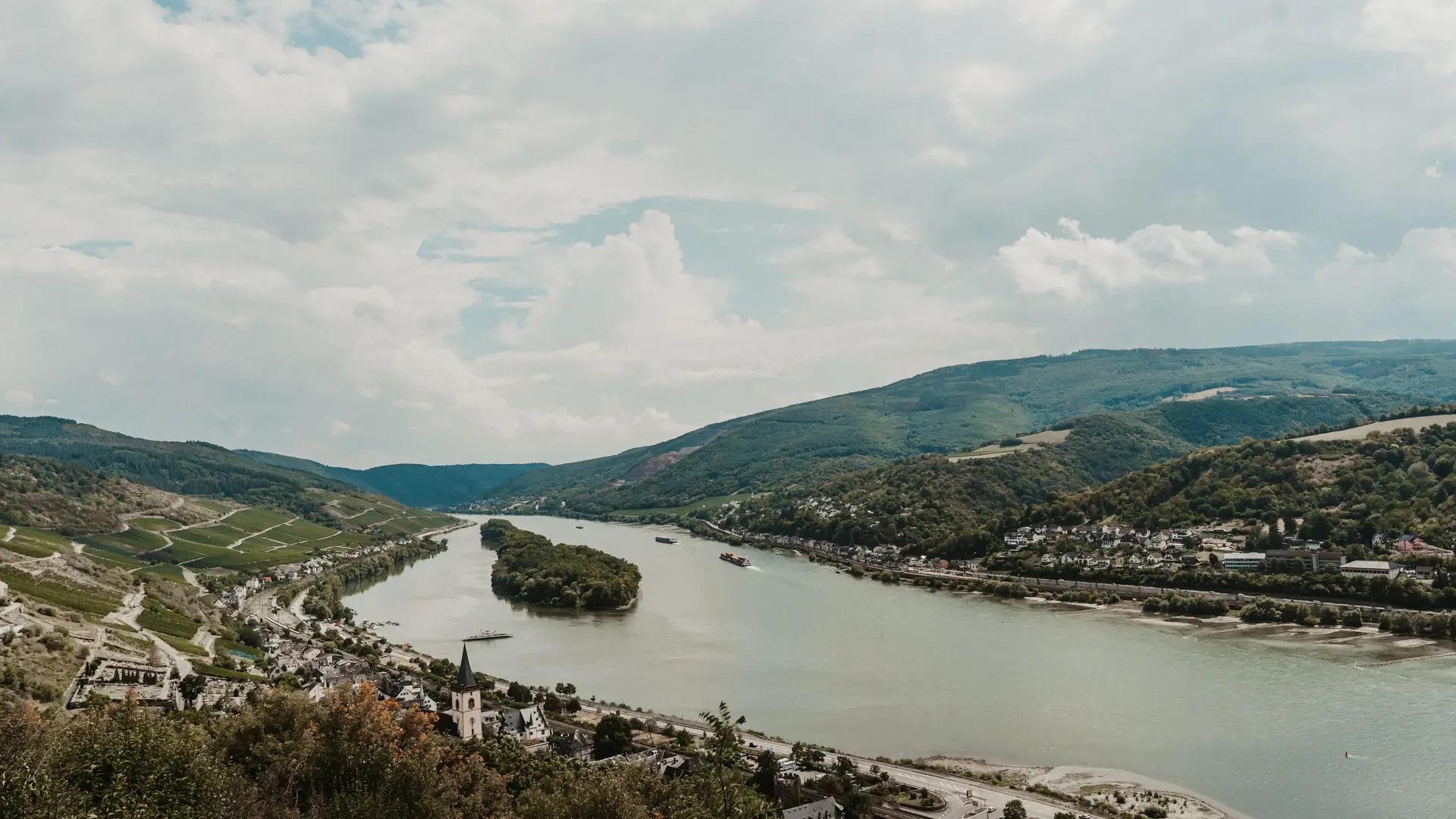 Aerial view of the Rhine winding past the town of Rüdesheim, surrounded by vineyard hills