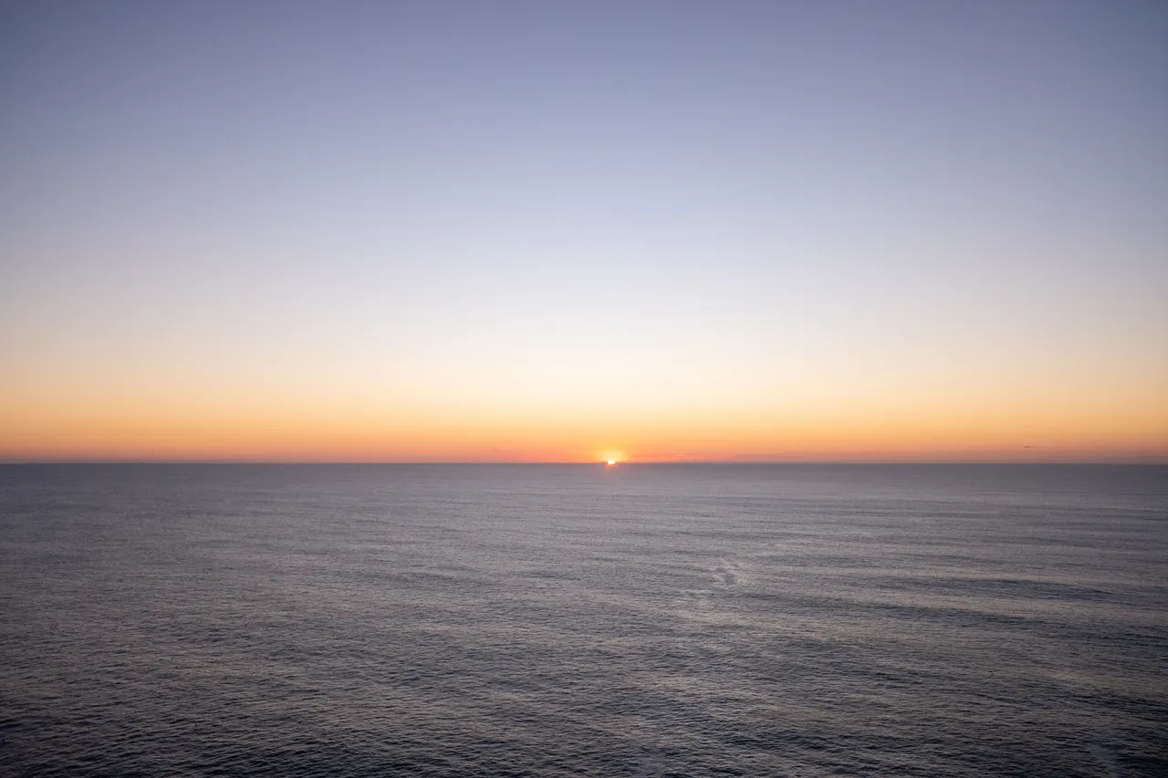 Peaceful sunset over the ocean, capturing a serene and tranquil atmosphere.